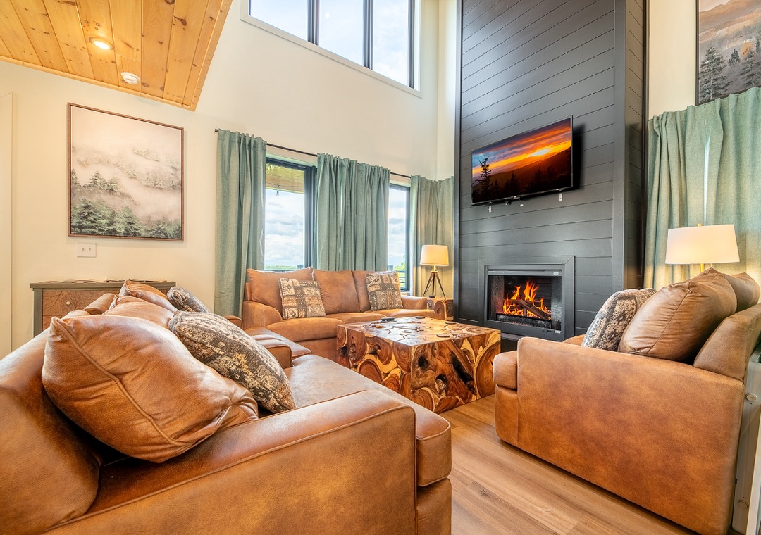 Curl up on plush leather sofas in front of the crackling fireplace, where soaring ceilings and natural light create your perfect mountain retreat after a day of adventure.