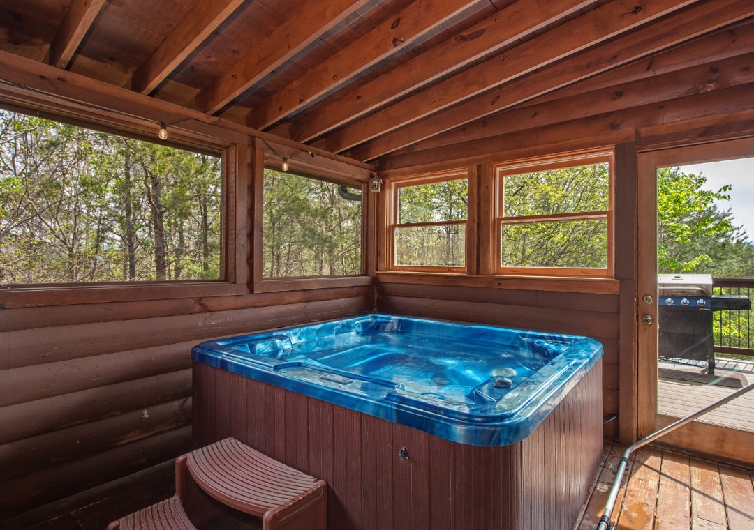 Sink into bubbling bliss in your private hot tub surrounded by floor-to-ceiling windows showcasing nature's beauty.
