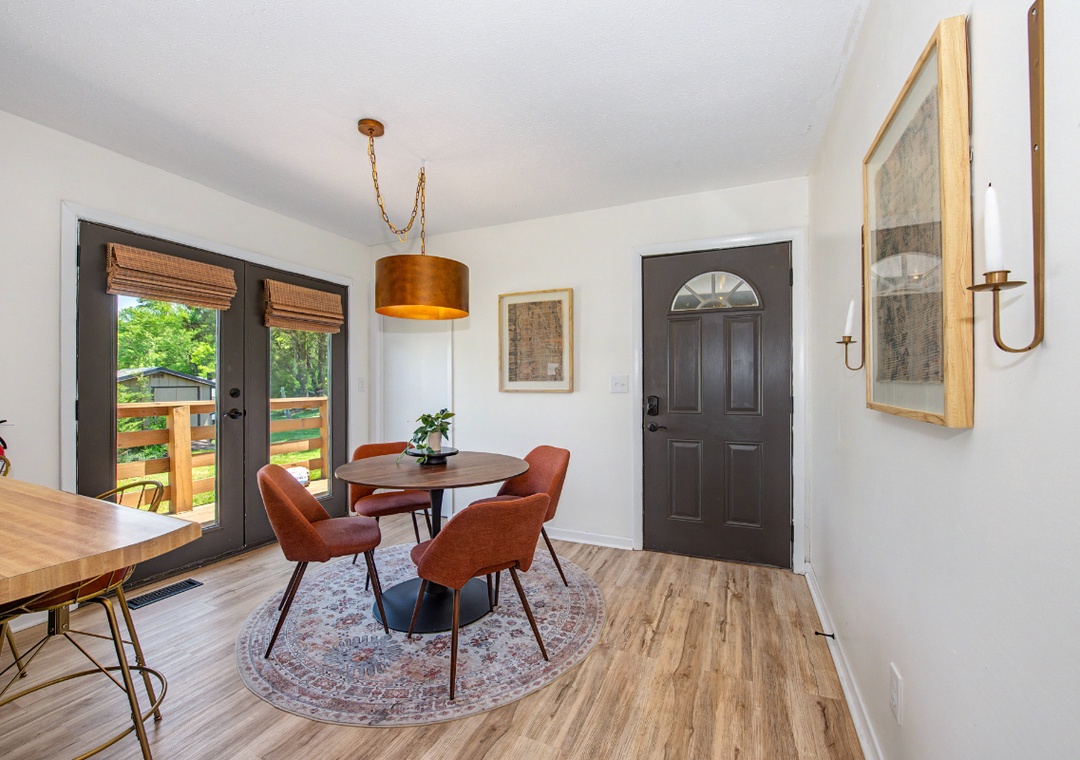 You'll love gathering around this stylish dining table, where warm copper tones and natural light create the perfect spot for memorable meals together.