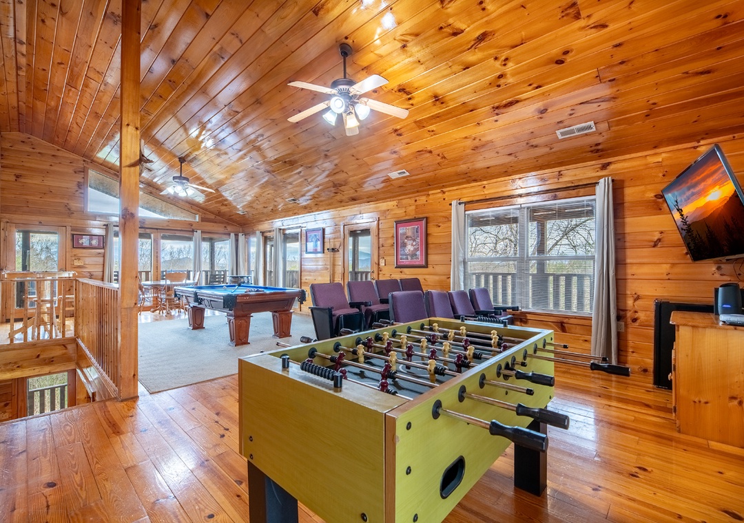 Challenge your friends to foosball while others relax in the seating area, all under rustic wood-paneled ceilings.