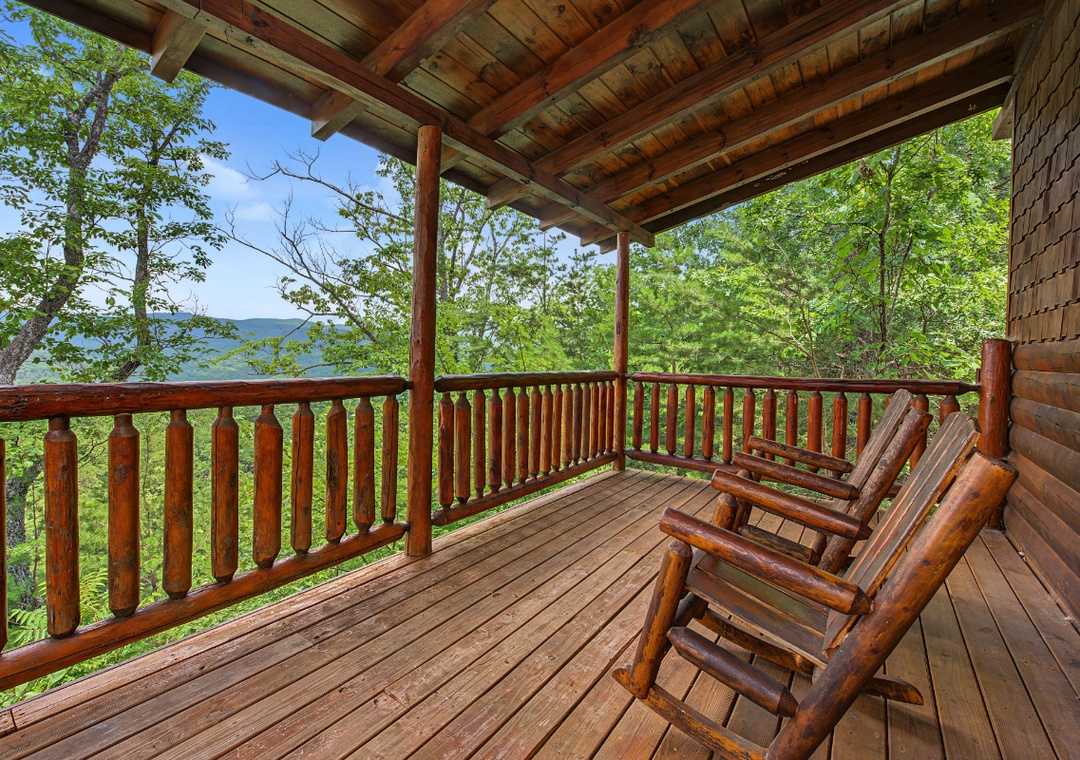 Settle into these handcrafted log chairs on your private deck, where morning coffee or evening relaxation pairs with stunning water views through lush, leafy surroundings.