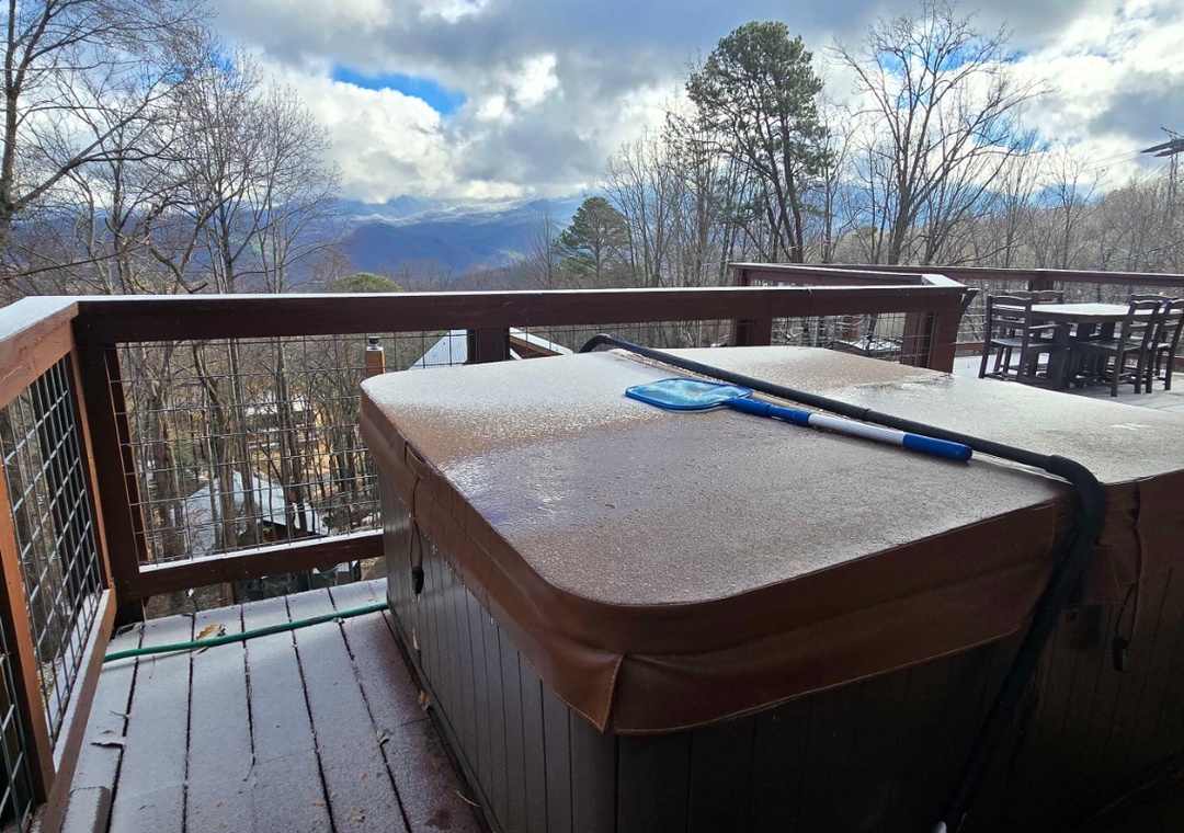 Soak in your bubbling hot tub while taking in breathtaking mountain views from your deck.