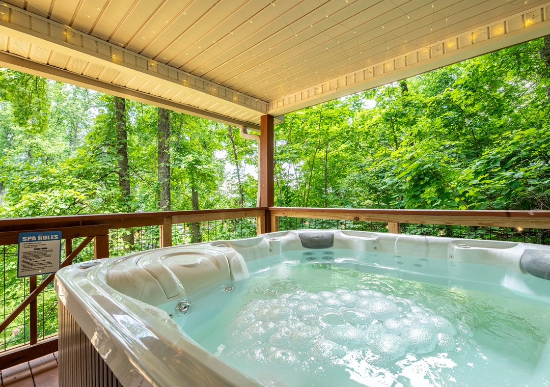 Soak away your cares in your private hot tub, surrounded by the calming sounds and lush green beauty of the forest just beyond your covered deck.