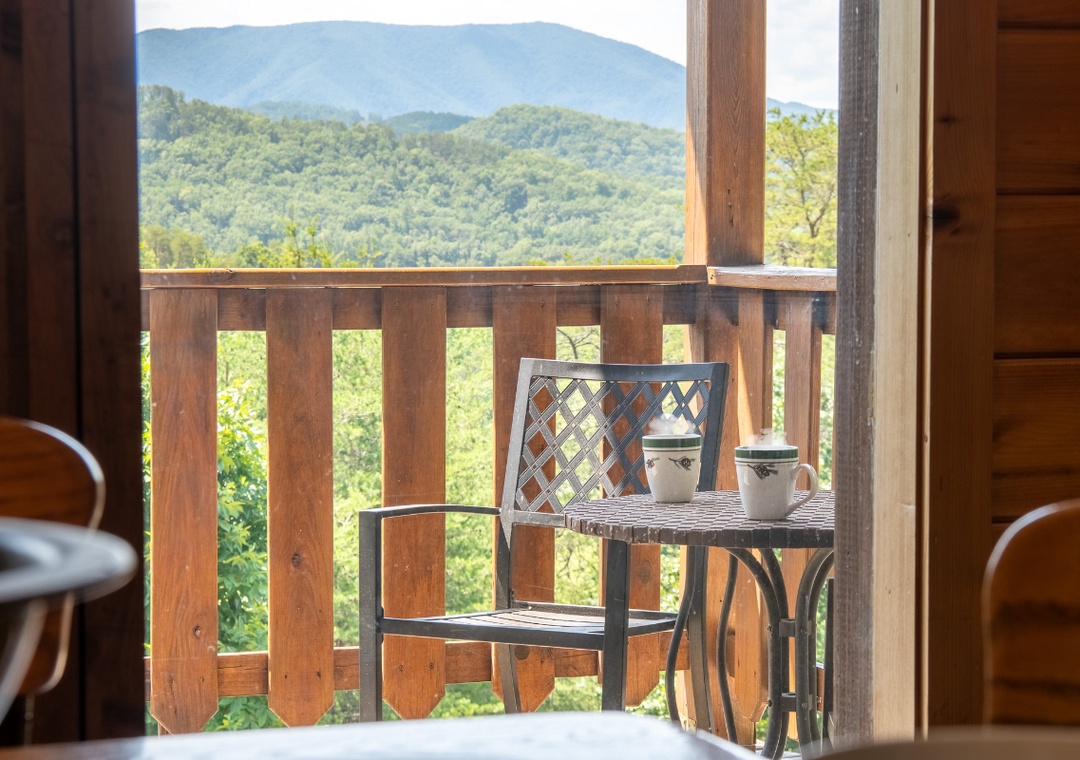 Picture your morning coffee on this private balcony, where rolling mountains and lush forests create a stunning backdrop. The peaceful seating area invites you to unwind and soak in nature's beauty.