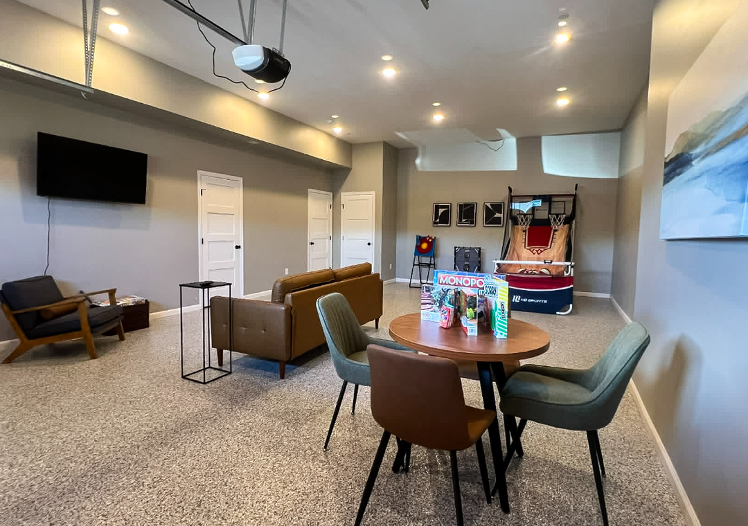 Your personal game room awaits, complete with a basketball hoop, lounge seating, and a TV for movie nights. Gather around the table for snacks and games, or sink into the cozy chairs after a fun match.
