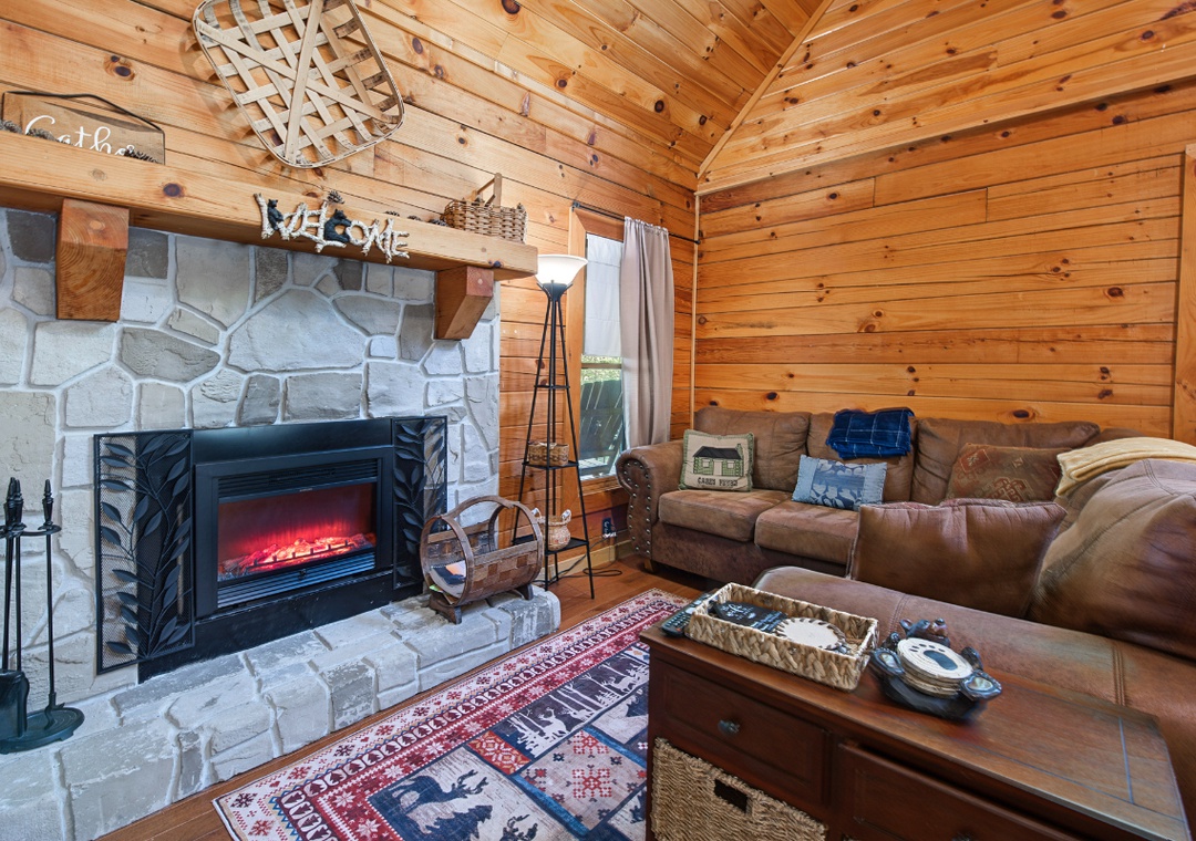 Sink into plush leather sofas in your cozy living room, where natural wood surrounds you and a glowing fireplace awaits those chilly evenings together.
