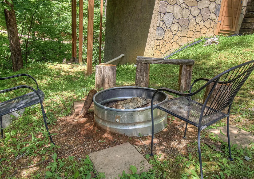 Gather around your private fire pit for cozy evenings surrounded by lush forest tranquility.