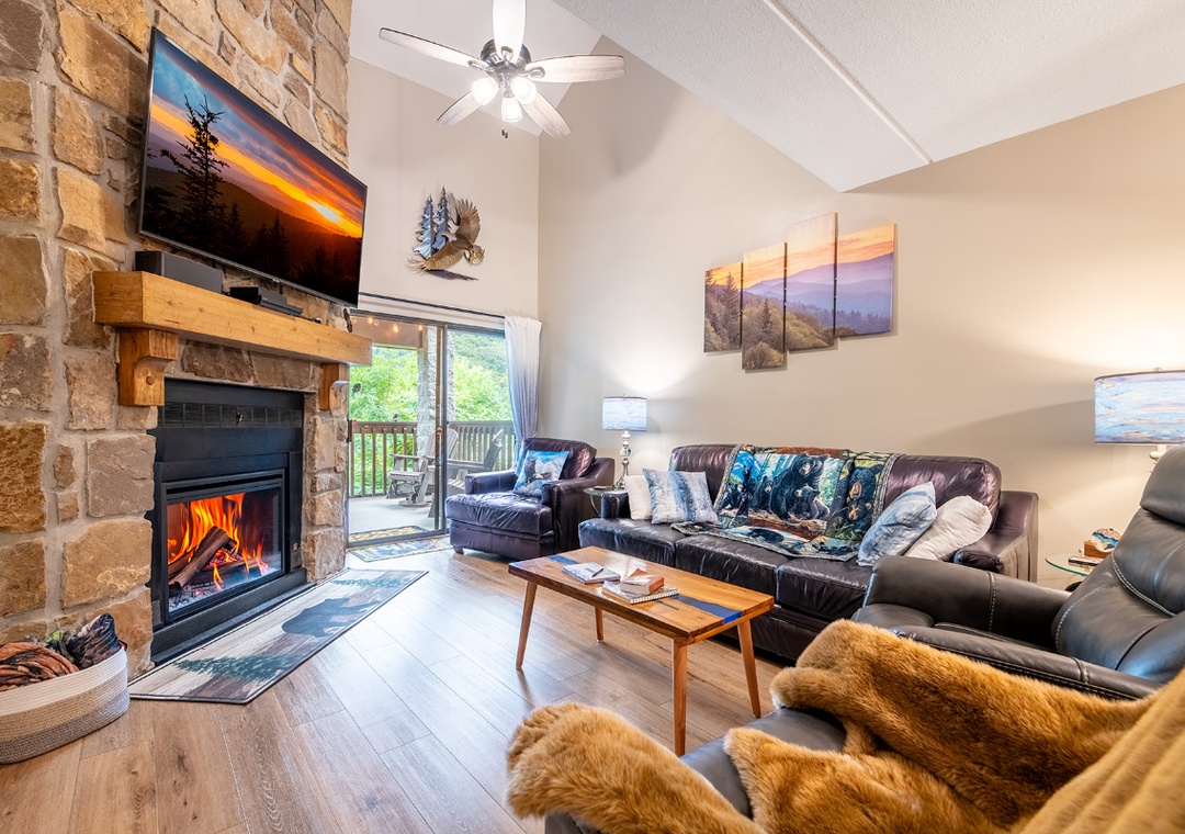 Cozy up in this inviting living room with a crackling stone fireplace and plush seating where your group can gather for memorable evenings together.