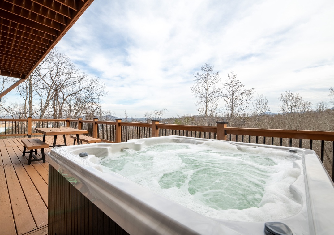 Soak in your private hot tub while taking in sweeping mountain views from this spacious deck.