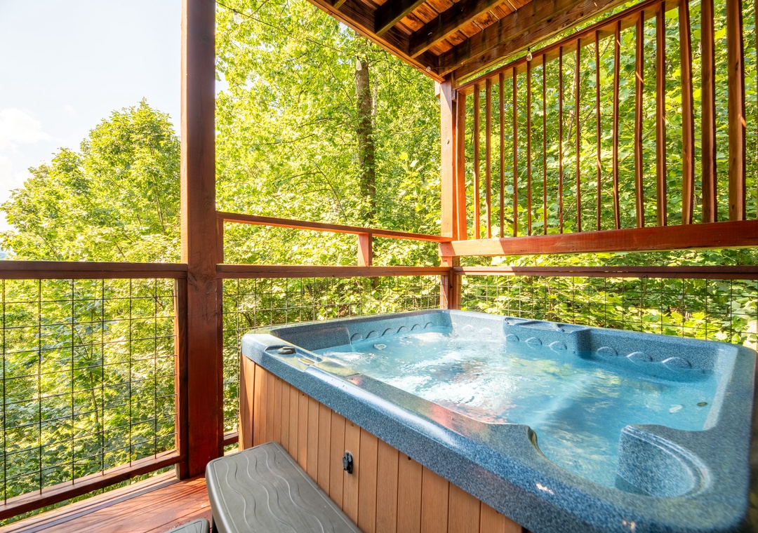 Soak in the bubbling hot tub on your private covered deck, surrounded by sunlit treetops and fresh mountain air. Pure relaxation waits for you here.