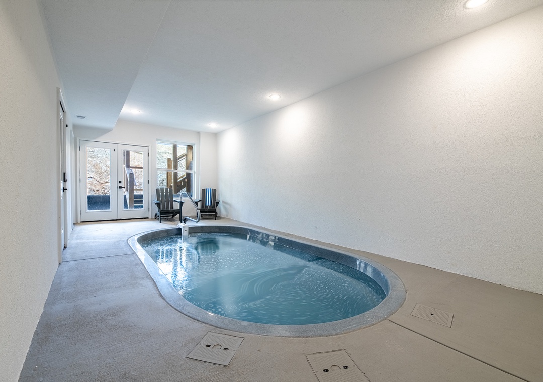 Dive into your private indoor oasis with this stunning heated pool, complete with poolside loungers for ultimate relaxation year-round.