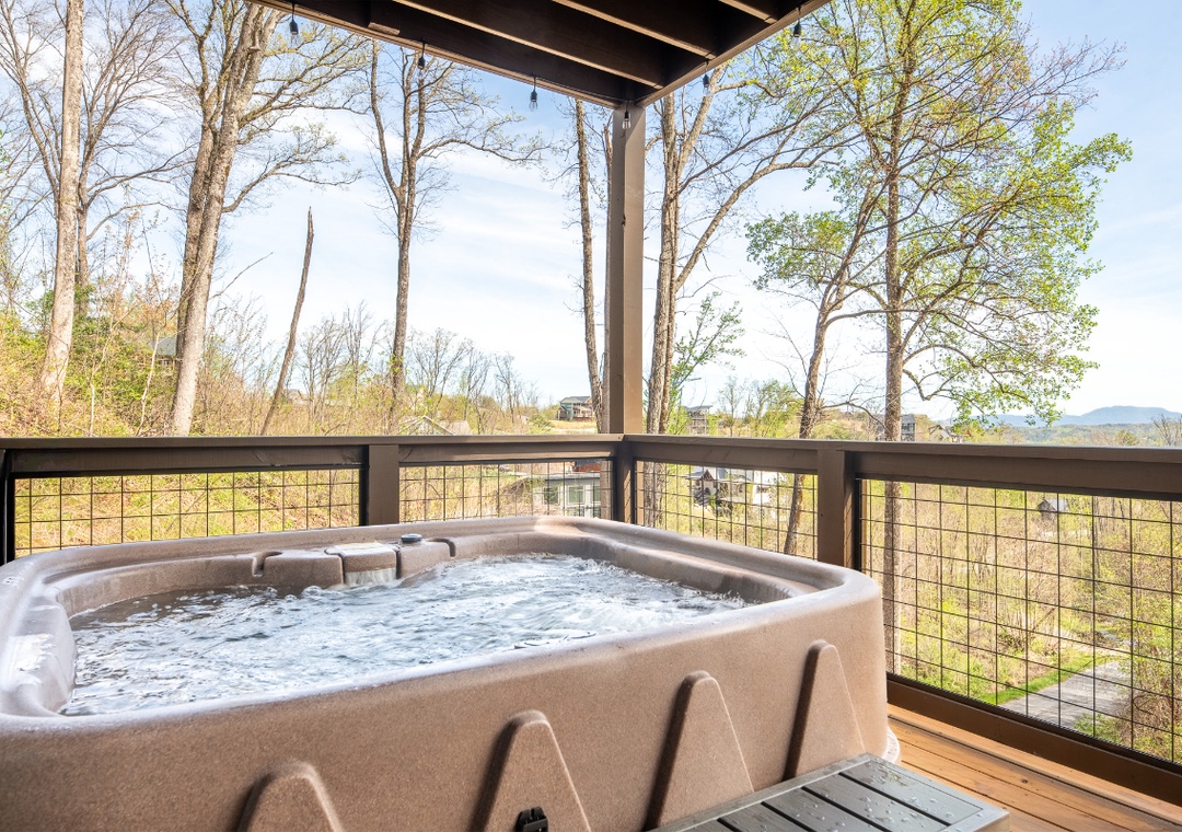 Soak in your private hot tub surrounded by lush forest views—the perfect spot to unwind and reconnect with nature.