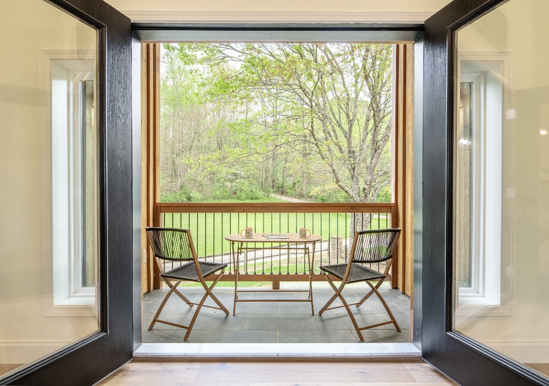 Step onto your private balcony, where morning coffee and peaceful moments await among the trees.