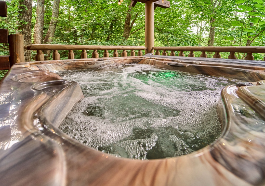 Soak your cares away in your private hot tub surrounded by lush forest—a peaceful outdoor retreat designed just for you.