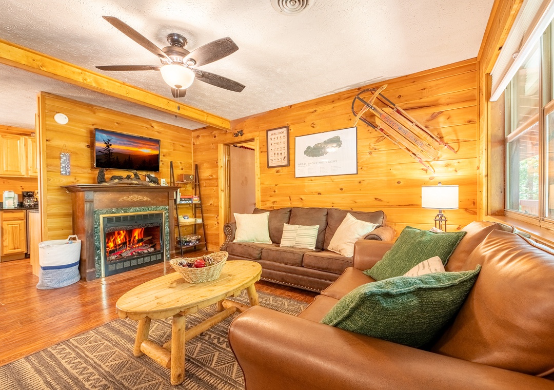 Curl up by the glowing fireplace or relax on plush seating in this warm, rustic living room—your cozy retreat after mountain adventures.