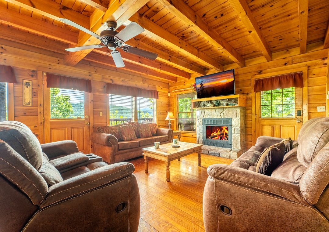 Sink into plush recliners beneath vaulted wood ceilings, where a crackling fireplace and mountain views create your perfect retreat for cozy evenings together.