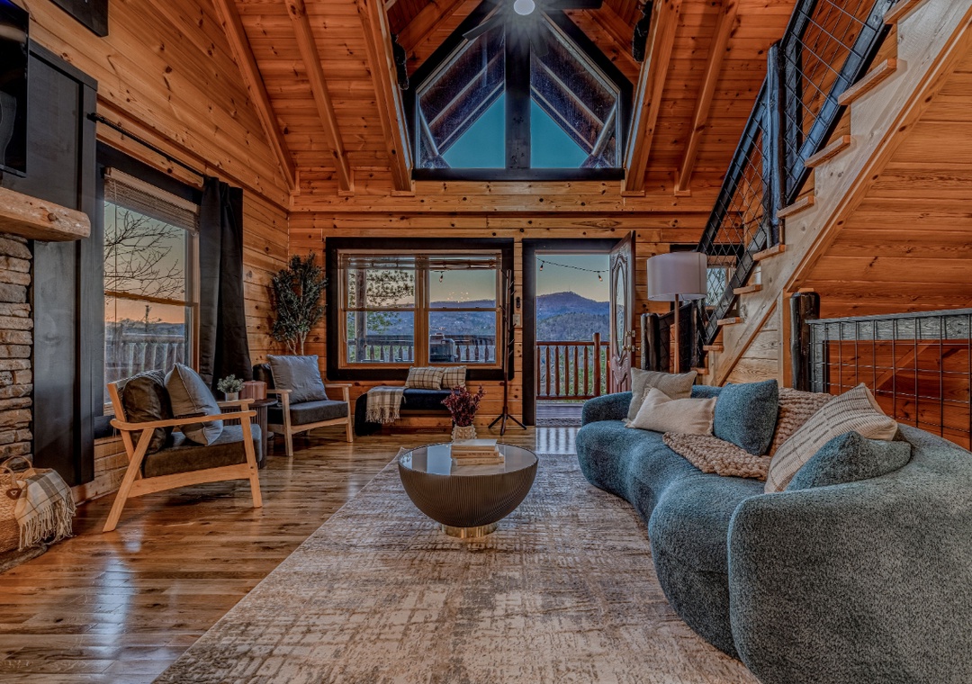 Cozy up in this stunning wood-beamed living room where mountain views frame your perfect retreat through picture windows.