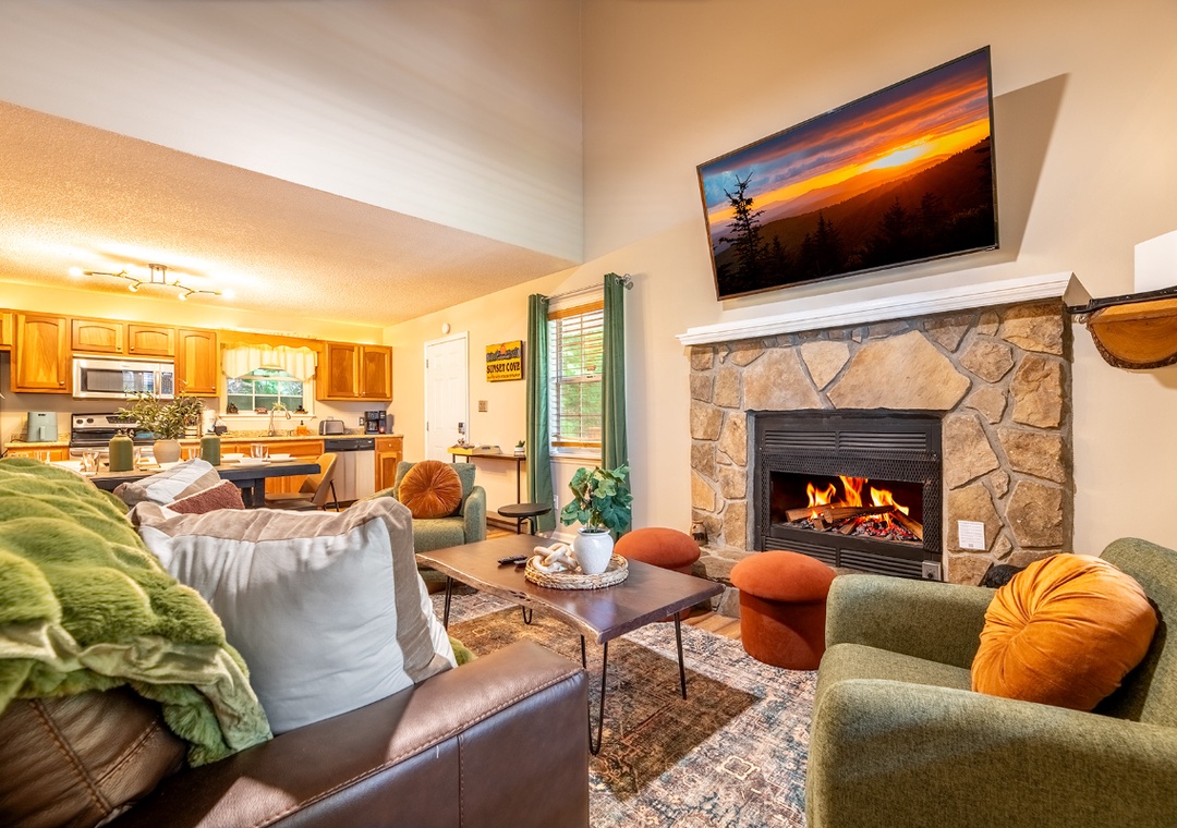 Gather around the stone fireplace in this welcoming living space, where plush seating set the scene for your cozy retreat moments together.