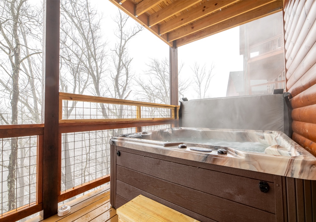 Soak in your private hot tub while trees create a peaceful backdrop—pure relaxation awaits you.