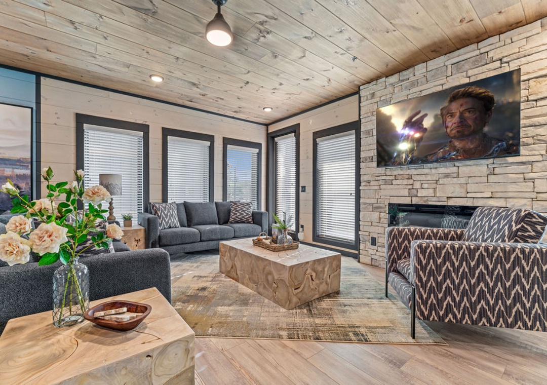 Unwind in this stunning living room where rustic wood beams meet modern comfort—your perfect retreat with cozy seating and entertainment.