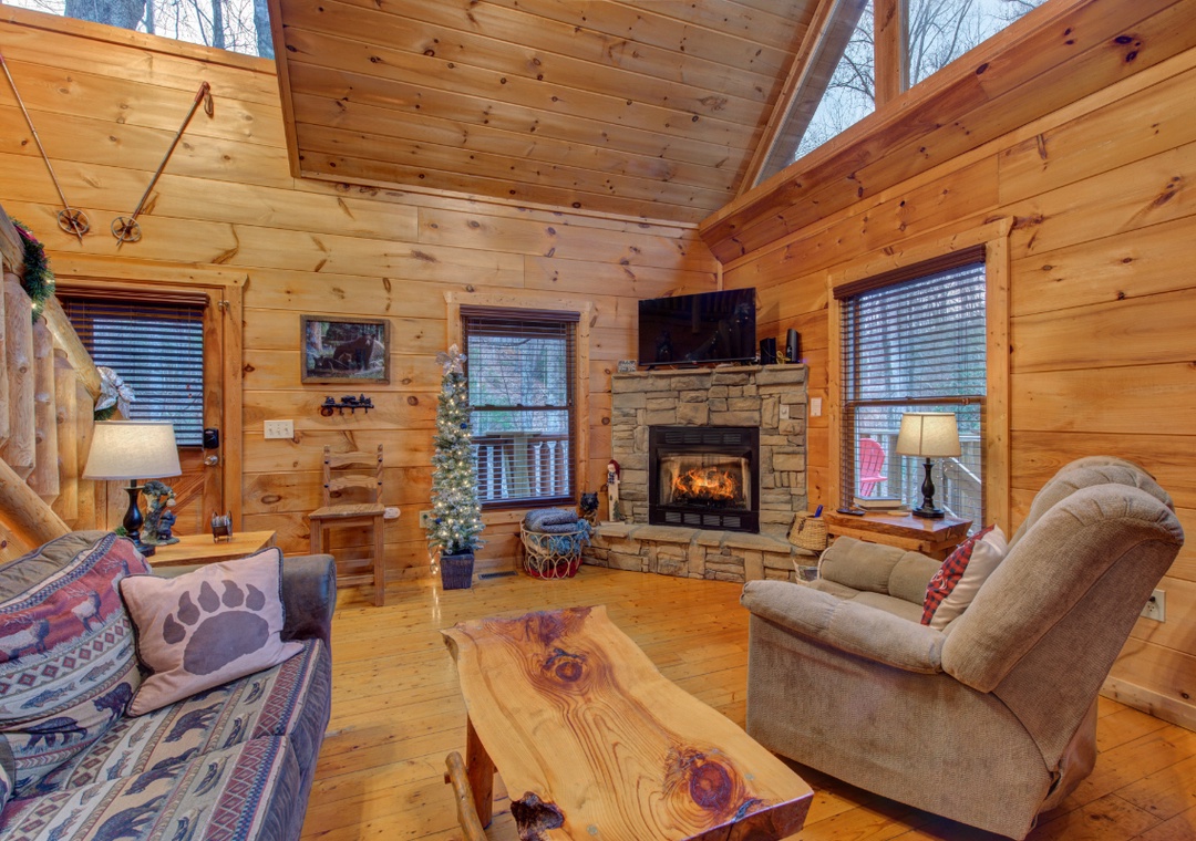 Curl up by your crackling fireplace in this cozy cabin retreat, where warm wood surrounds you through every window.