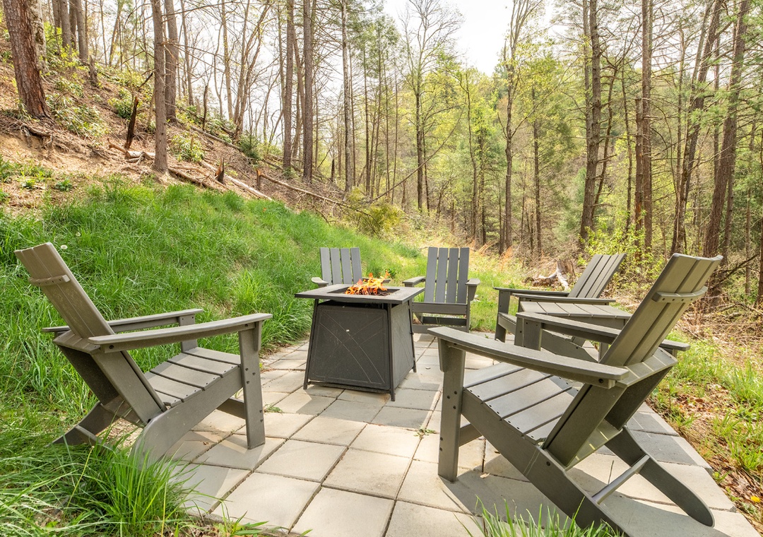 Gather around your private fire pit surrounded by towering trees, where crackling flames and forest serenity create perfect evening moments.