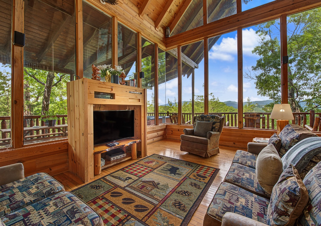 Relax in your sun-drenched living room with vaulted ceilings, cozy fireplace, and floor-to-ceiling windows framing lush mountain views from every angle.