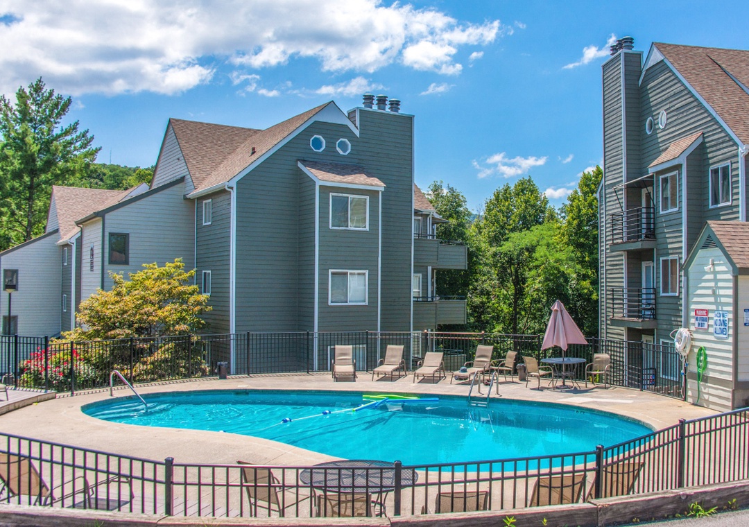 The resort features a welcoming heated seasonal outdoor pool area with lounge chairs, perfect for a sunny getaway.