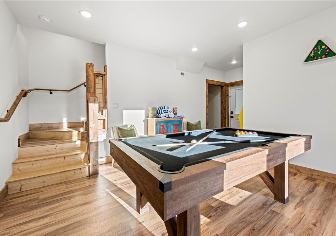 Challenge friends to pool in your private game room, complete with rustic wood stairs and cozy seating nook.