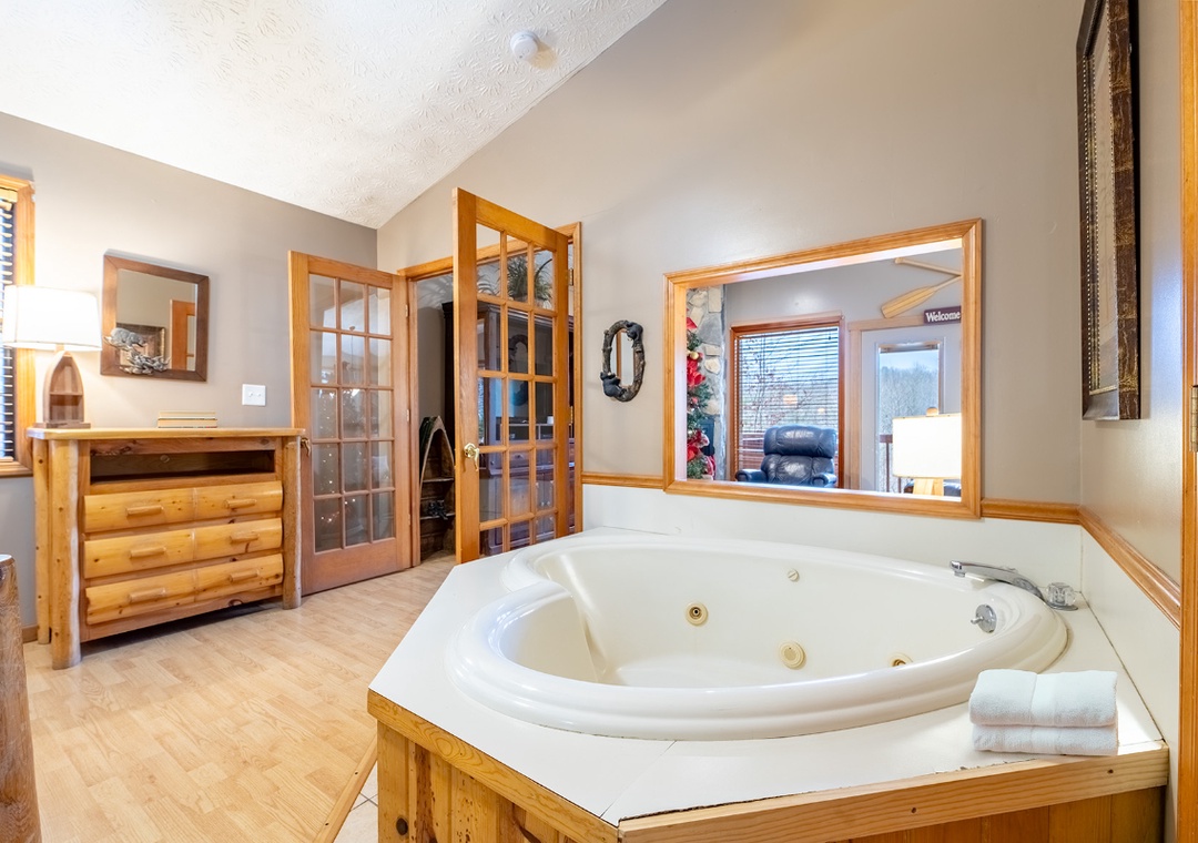 Sink into your private jetted tub and let warm bubbles melt away stress in this rustic-elegant bathroom retreat.
