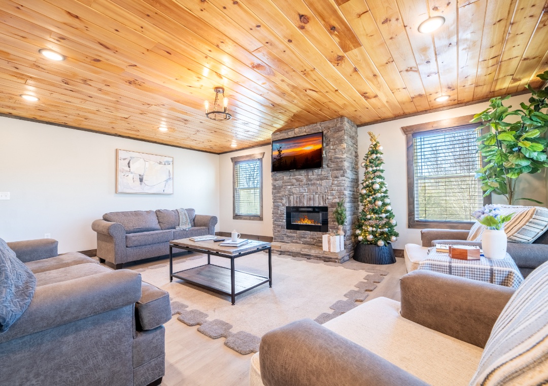 Cozy up in your spacious living room with warm wood ceilings, stone fireplace, and plush seating perfect for mountain evenings.