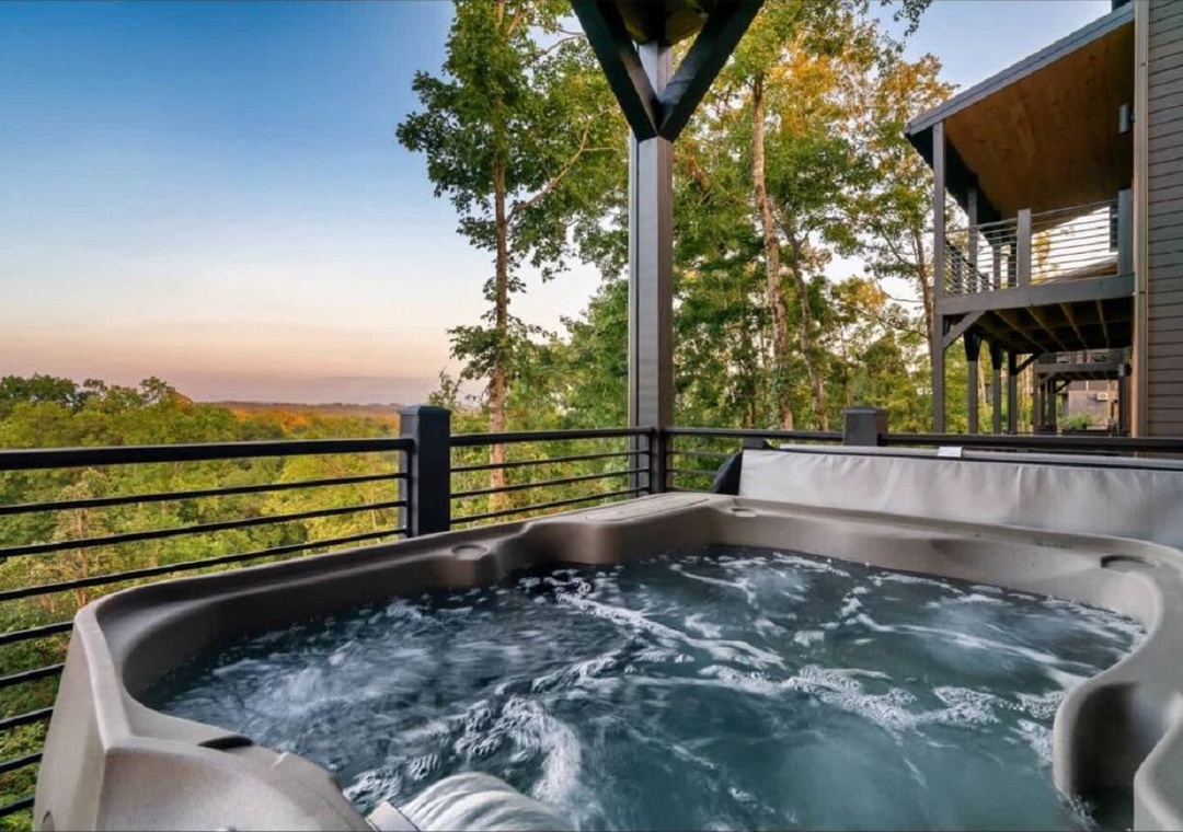Soak away the day in your private hot tub overlooking lush forest views, where the sunset paints the sky in soft pastels and serenity surrounds you.