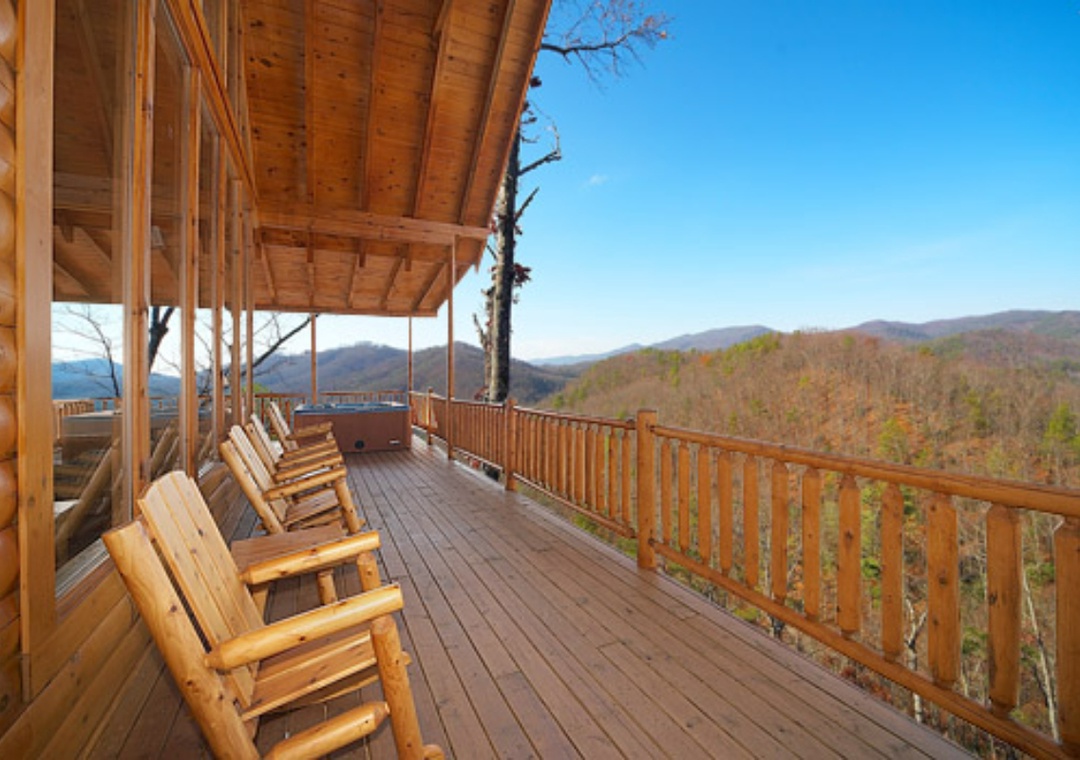 This covered deck overlooks mountain vistas with comfortable seating and a hot tub, ideal for peaceful mornings or starlit evenings in the surrounding wilderness.