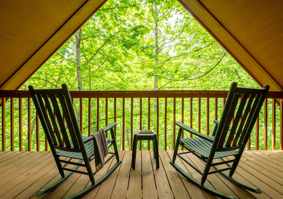Unwind in your private rocking chairs and gaze into lush forest canopy—a peaceful retreat awaits you with every gentle sway.