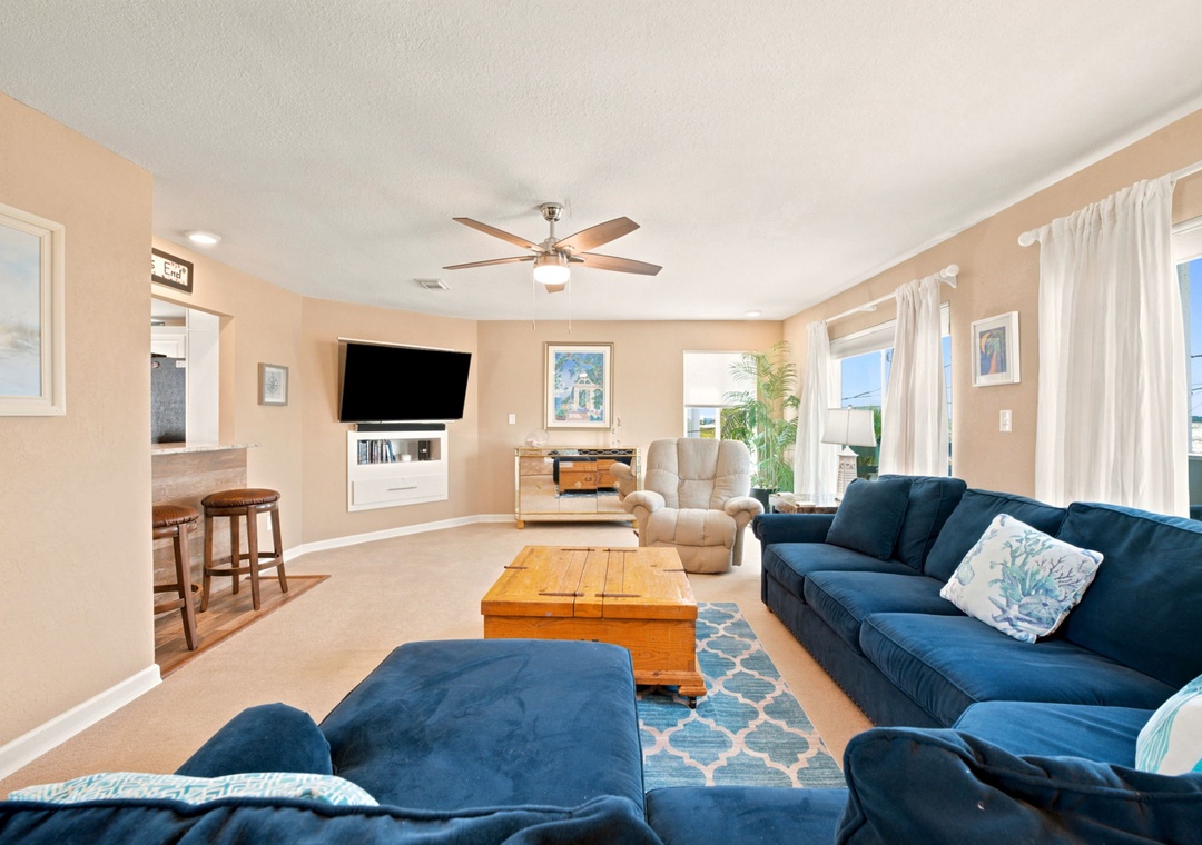 Large sectional sofa and mounted flat-screen TV in the living room