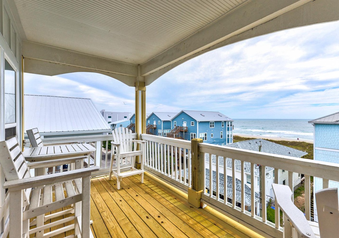 Sip your morning coffee on your private covered balcony while gazing at the sparkling ocean just steps away, with coastal breezes and endless sea views.