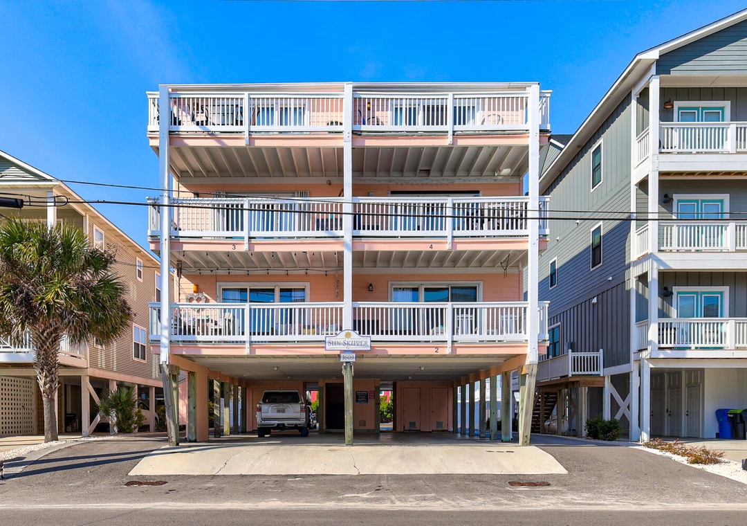 Bright beach house with multiple decks and covered parking in a charming coastal neighborhood.