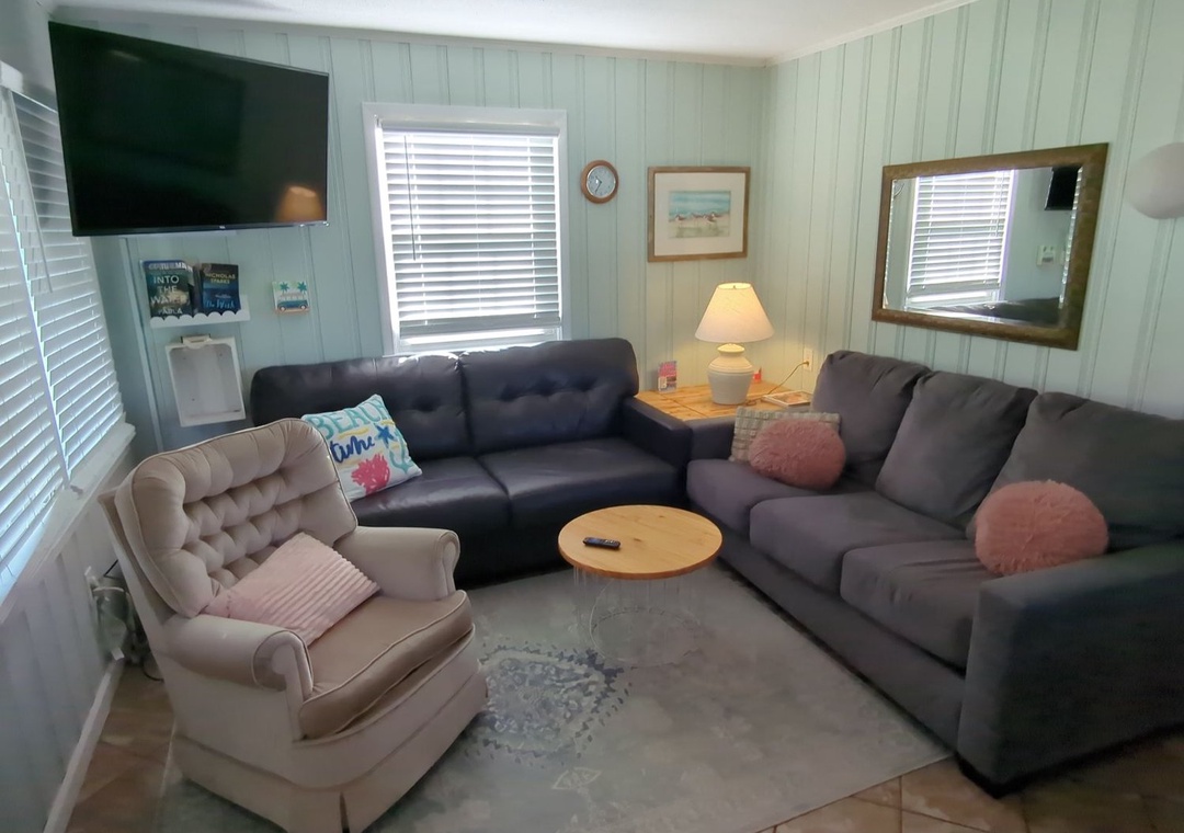 Sink into plush sectional seating where coastal charm meets comfort. Your relaxing retreat features cozy furnishings and peaceful ambiance.