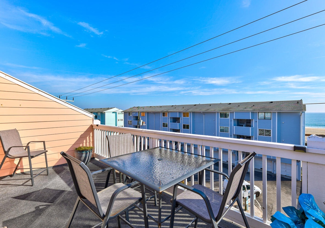 Enjoy your morning coffee at this private balcony table while soaking up stunning ocean views and coastal charm.