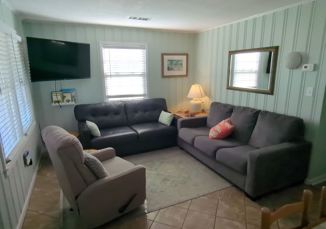 Sink into comfortable sofas and unwind in your bright living space, complete with flat-screen TV for cozy movie nights together.