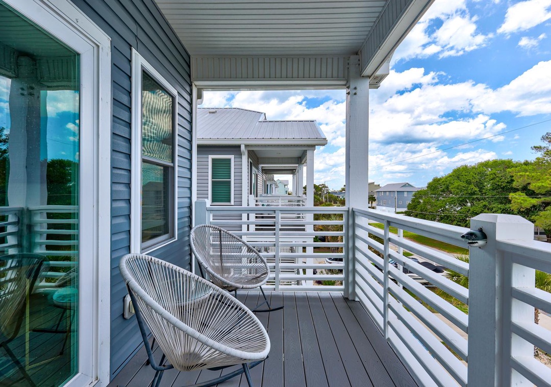 Step onto your private balcony and settle into modern seating with peaceful views of the lush neighborhood—perfect for morning coffee or unwinding after a day of adventure.