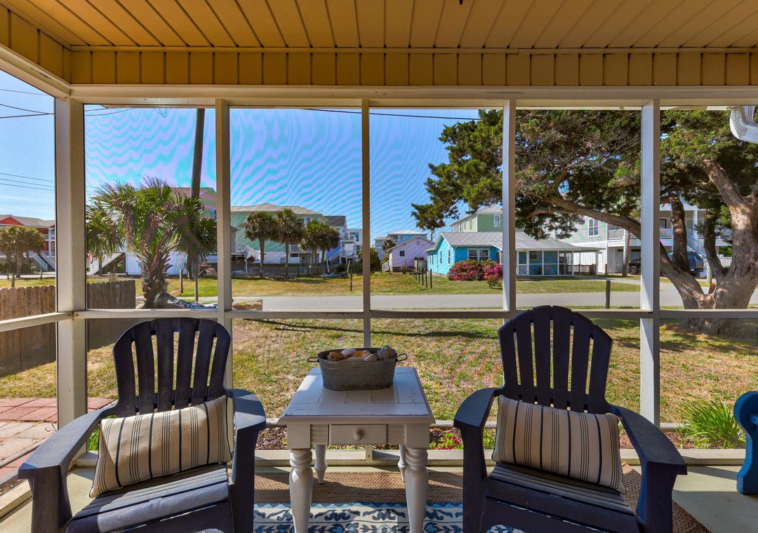 Your screened porch offers comfortable seating where you can relax with morning coffee while watching the peaceful neighborhood come to life.