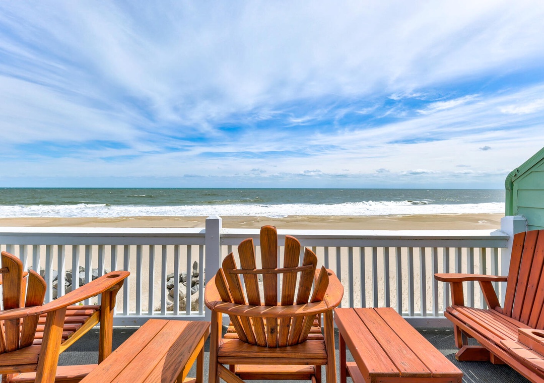 Settle into Adirondack chairs on your oceanfront deck where gentle waves meet endless blue skies, perfect for morning coffee or sunset cocktails.