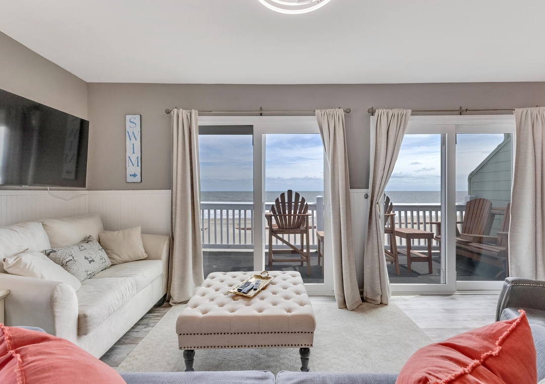 Relax in your bright living room with ocean views through sliding doors to your private balcony with Adirondack chairs.