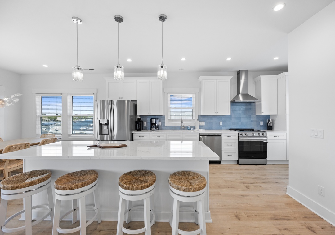 Your dream kitchen awaits with gleaming white cabinets, modern appliances, and a spacious island perfect for morning coffee or evening conversations.