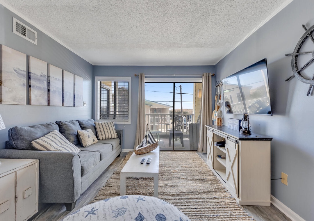 Unwind in your coastal-themed living room with plush sectional seating, nautical décor, and calming blue tones that create the perfect retreat.