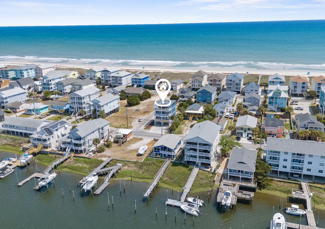 Coastal community with beachfront homes, private docks, and direct ocean access creating the perfect waterfront getaway destination.