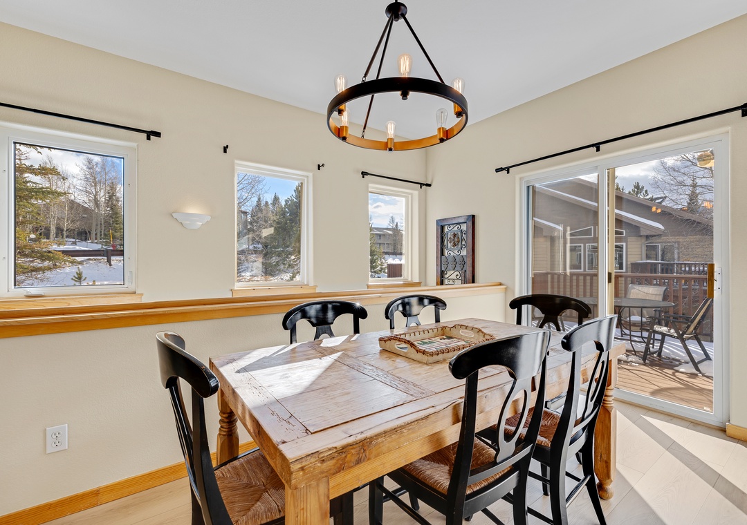Your dining space features rustic charm with mountain views and deck access for memorable meals.