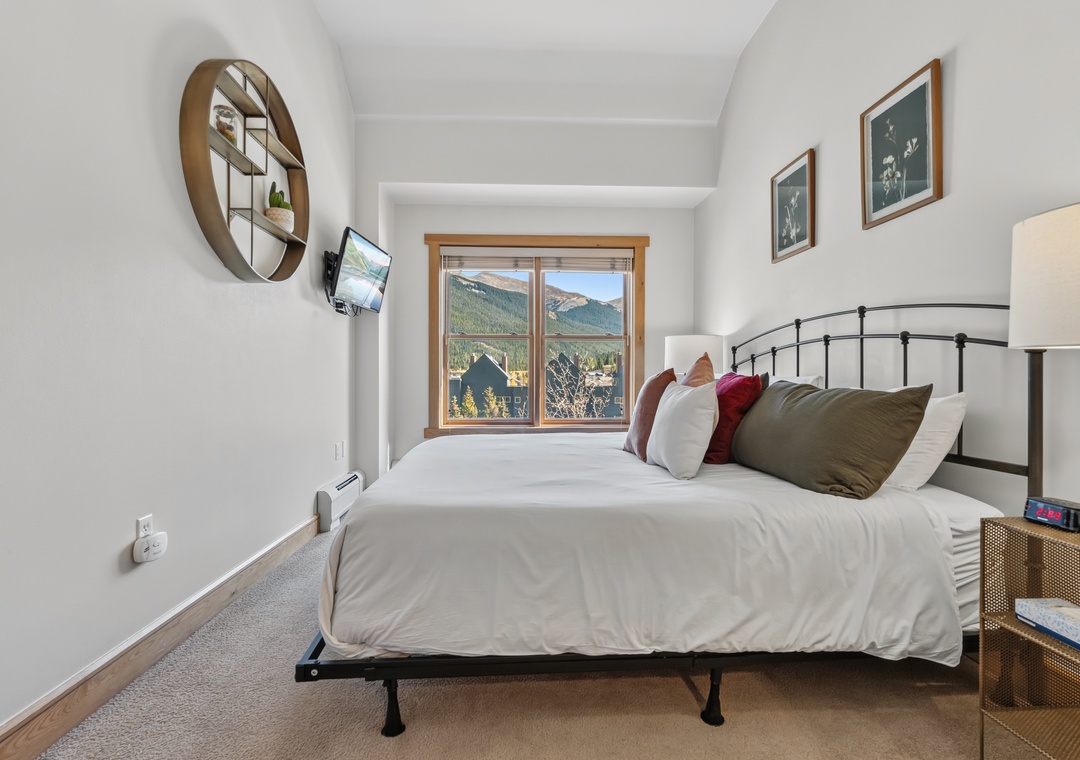 Wake up to breathtaking mountain views through your bedroom window. This serene retreat offers plush bedding and modern comforts, creating your perfect alpine escape.