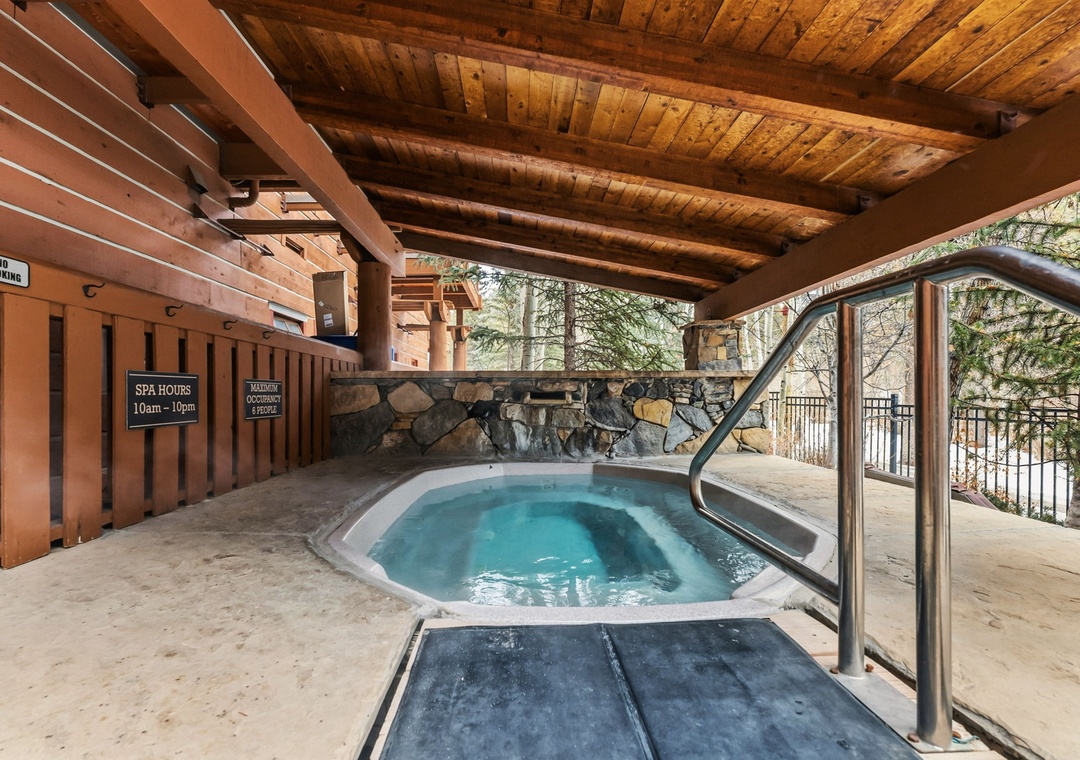 Unwind in this secluded hot tub beneath rustic wooden beams, where warm waters and mountain views create your perfect retreat.
